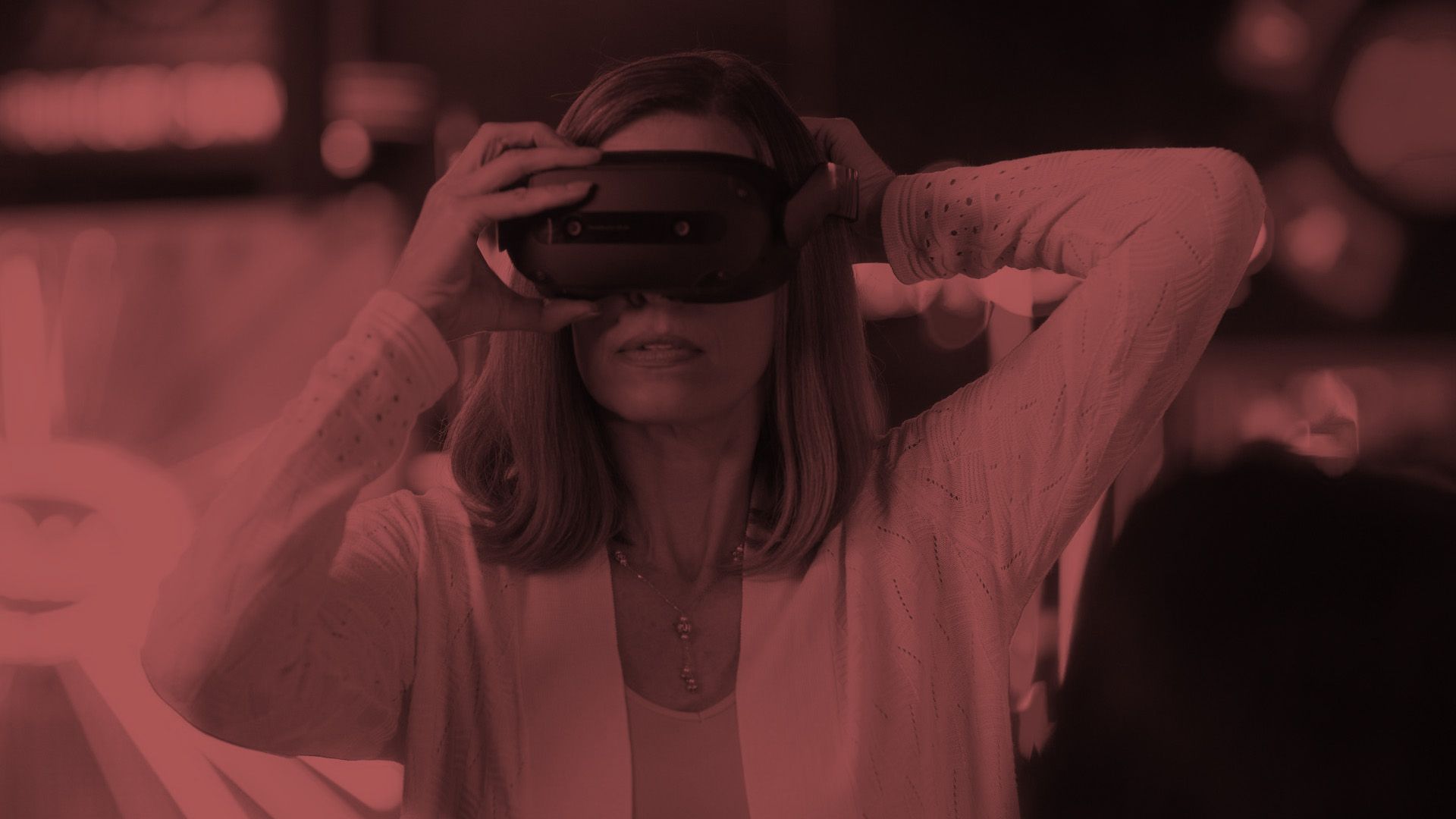 A header image: a woman putting on a Lenovo VRX headset with a crimson overlay.